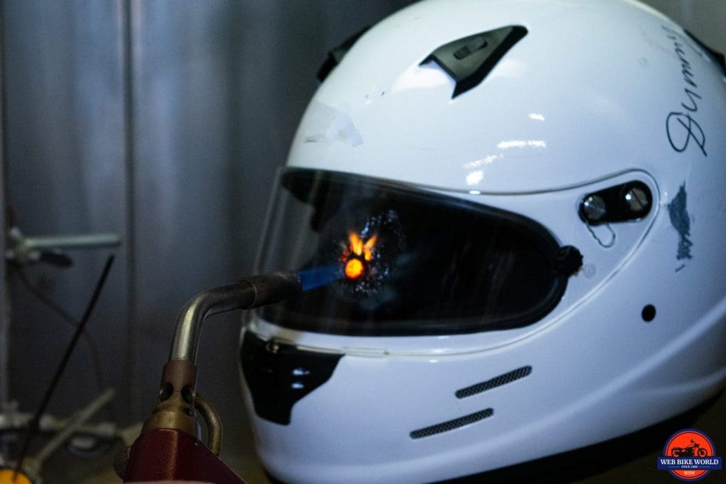 Using a torch on a helmet visor at the Snell laboratory.