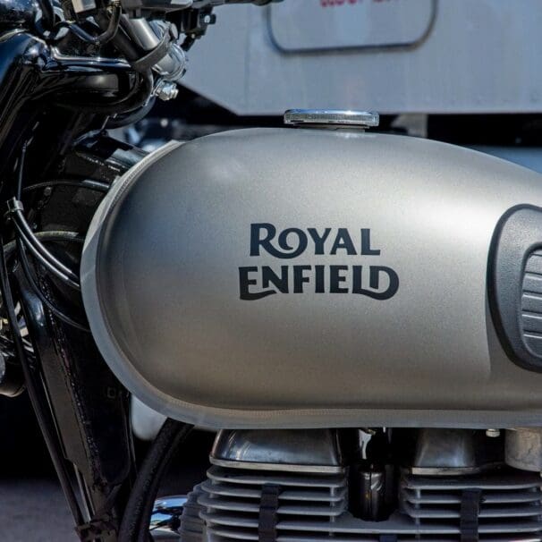 The Royal Enfield brand name painted on a gas tank.