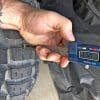Measurement of tread depth on the rear Motoz Tractionator Adventure Tire.