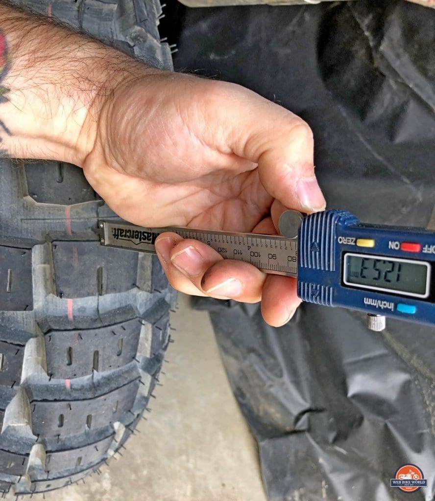 Measurement of tread depth on the rear Motoz Tractionator Adventure Tire.