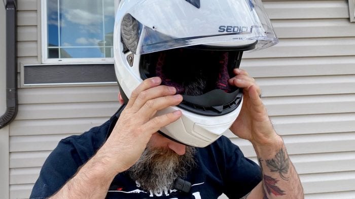 Donning the Sedici Strada II helmet Donning the Sedici Strada II helmet