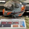 The Klim Krios Pro with a Sena 10 EVO installed on it being weighed.