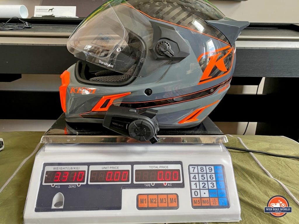 The Klim Krios Pro with a Sena 10 EVO installed on it being weighed.