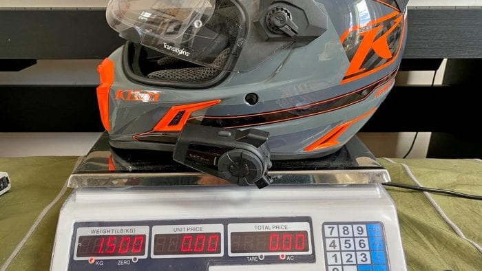 The Klim Krios Pro with a Sena 10 EVO installed on it being weighed.