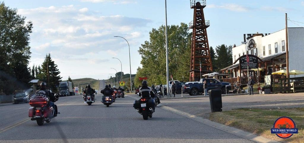 The Twin Cities Saloon in Longview, Alberta with motorcycles riding up to park in the lot.