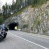 A Harley Davidson parked in front of a tunnel.