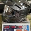 The Touratech Aventuro Traveller Carbon helmet on a scale (in kg)