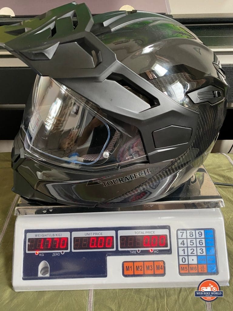 The Touratech Aventuro Traveller Carbon helmet on a scale (in kg)