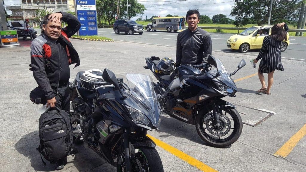 bikers posing with kawasaki bikes