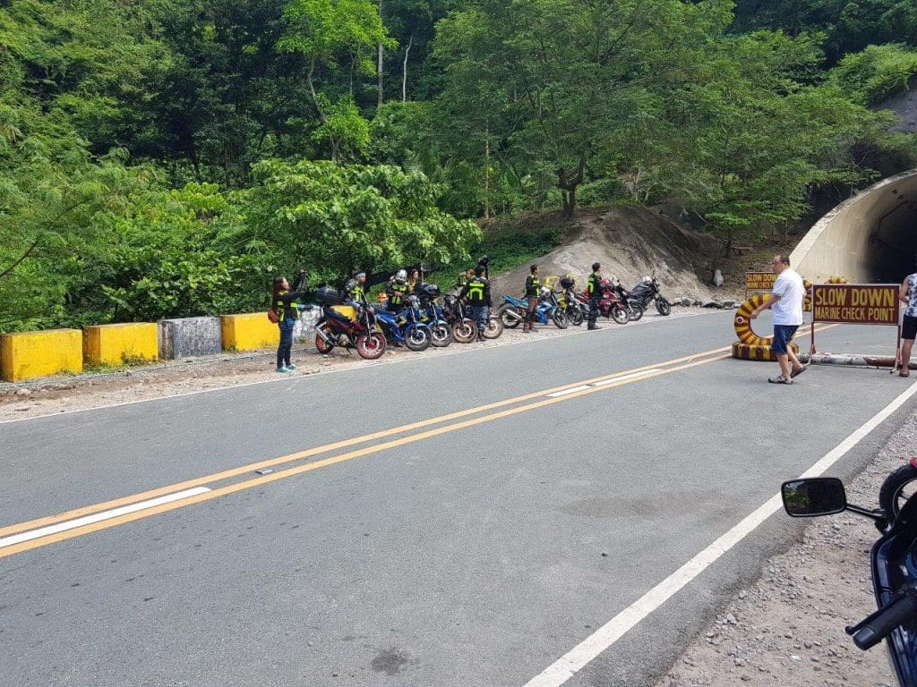 a group of bikers near a tunnel