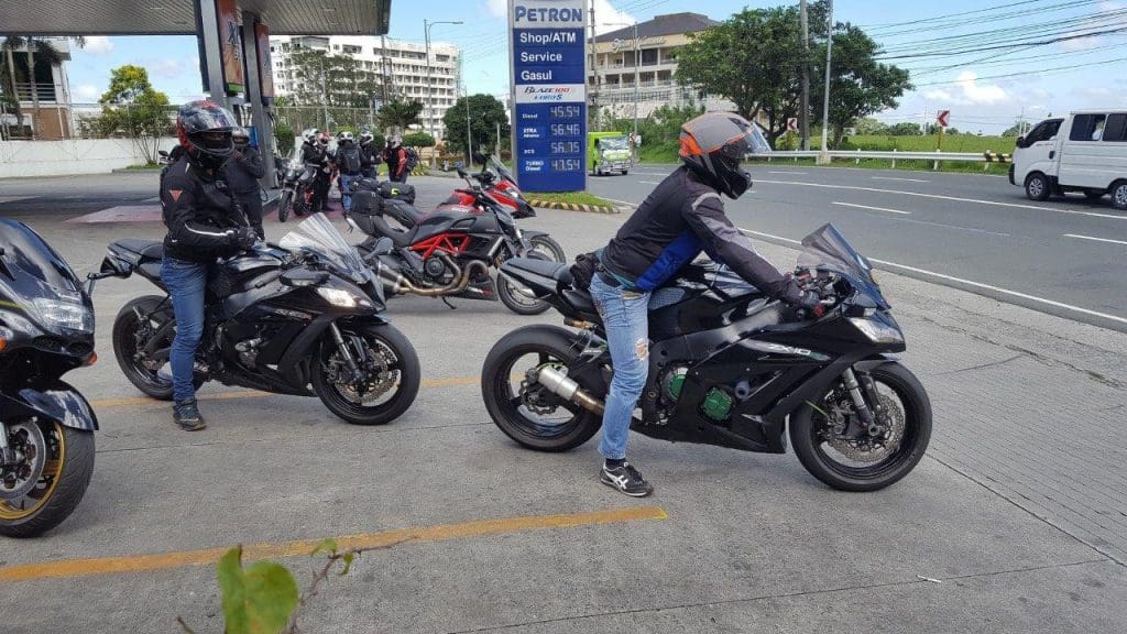 Various bikes parked at gas station