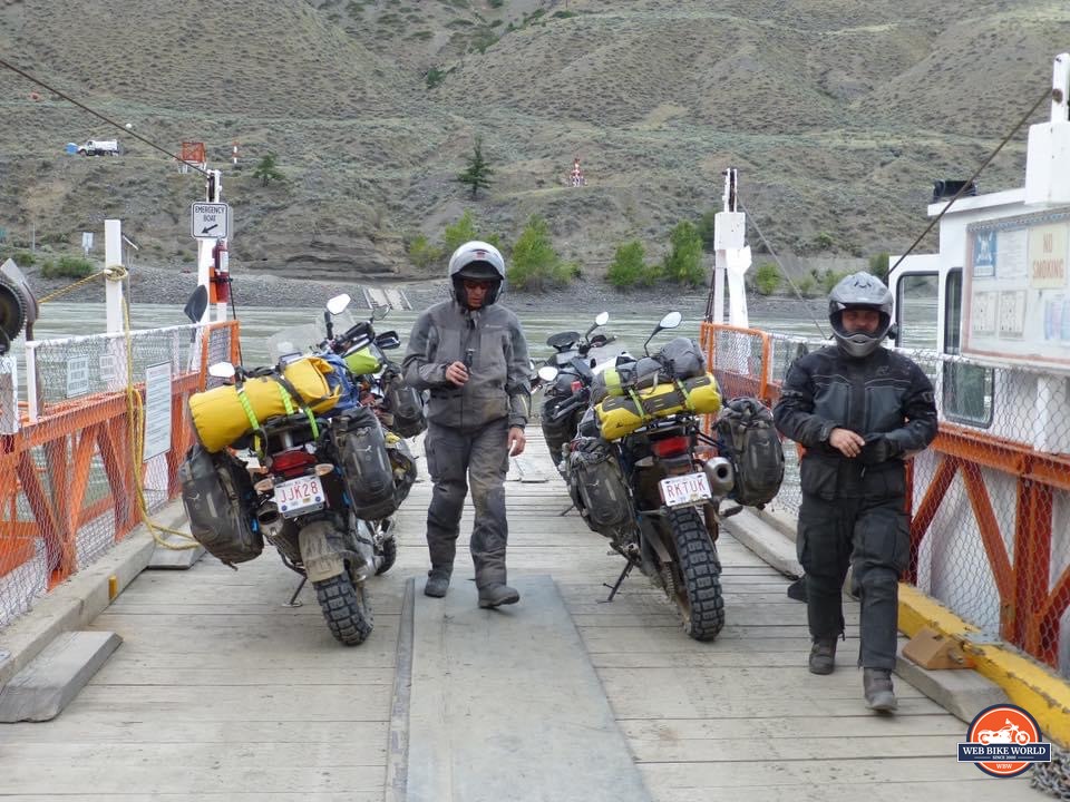 Riders on a reaction ferry with motorcycles near 100 Mile House, Alberta.