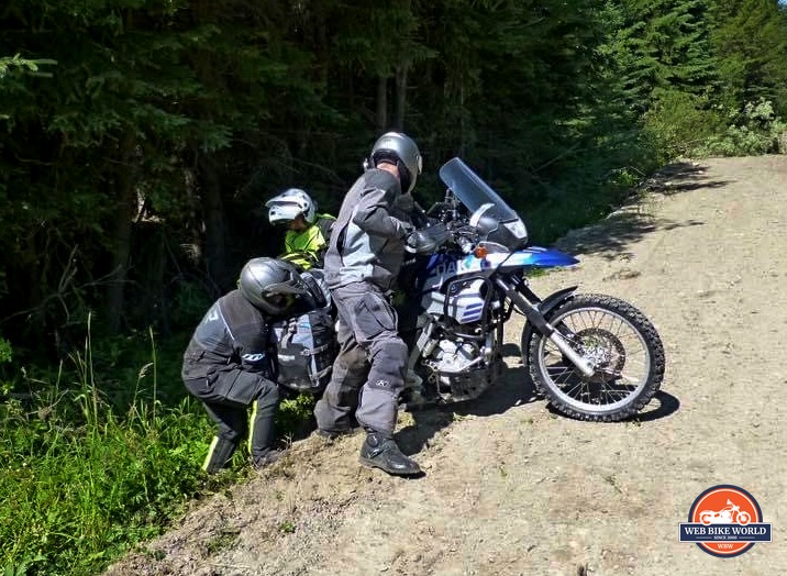 Jim Pruner and friends working together to get a bike out of the ditch.