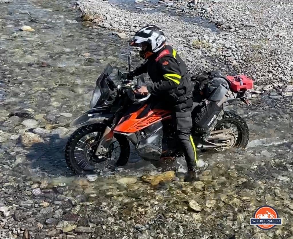 Jim Pruner crossing a stream on his KTM 790 Adventure.