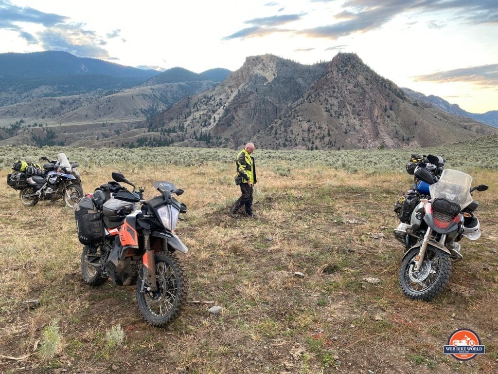 Three adventure motorcycles parked off road in British Columbia.