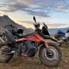 A KTM 790 Adventure and BMW R1200GS parked in front of a sunset in British Columbia, Canada.