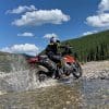 Jim Pruner riding his KTM 790 Adventure through water while wearing the Arai XD-4 helmet.