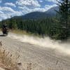 Jim Pruner riding his KTM 790 Adventure down a dusty gravel road wearing the Arai XD-4 helmet.