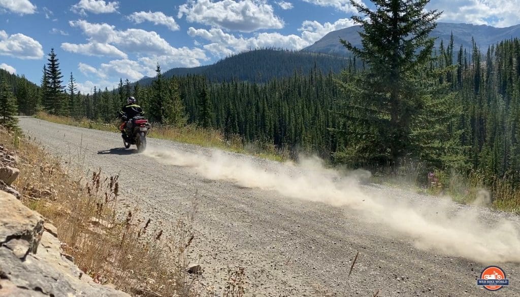 Jim Pruner riding his KTM 790 Adventure down a dusty gravel road wearing the Arai XD-4 helmet.