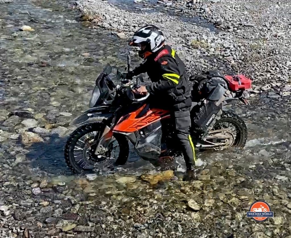 Jim Pruner crossing a stream on a KTM 790 Adventure while wearing the Joe Rocket Canada Whistler Adventure boots.
