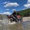 Jim Pruner riding through a stream while wearing the Joe Rocket Canada Whistler Adventure boots.