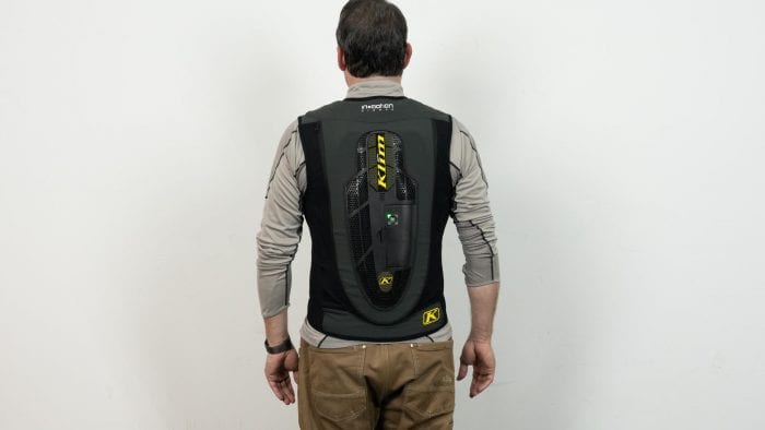 Rear view of individual wearing an inflated Klim Ai-1 airbag vest Rear view of individual wearing an inflated Klim Ai-1 airbag vest