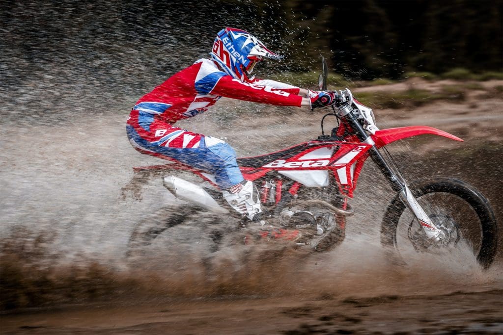 Rider on a Beta 430 RR-S high speed across a stream.