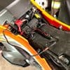 The 12V battery harness connected to the battery terminals on a KTM 790 Adventure.