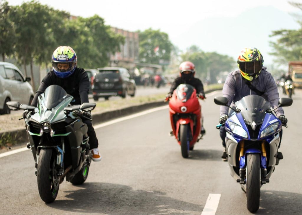 Motorcycle Riders wearing gear on the street