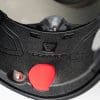 Close up of helmet air release button and chin vent adjuster