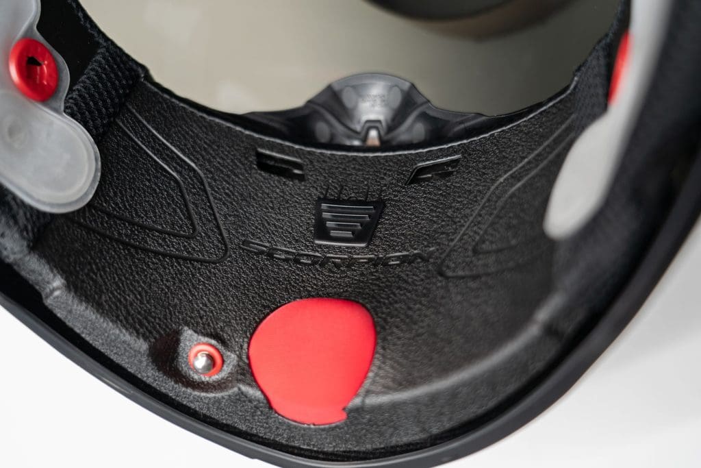 Close up of helmet air release button and chin vent adjuster