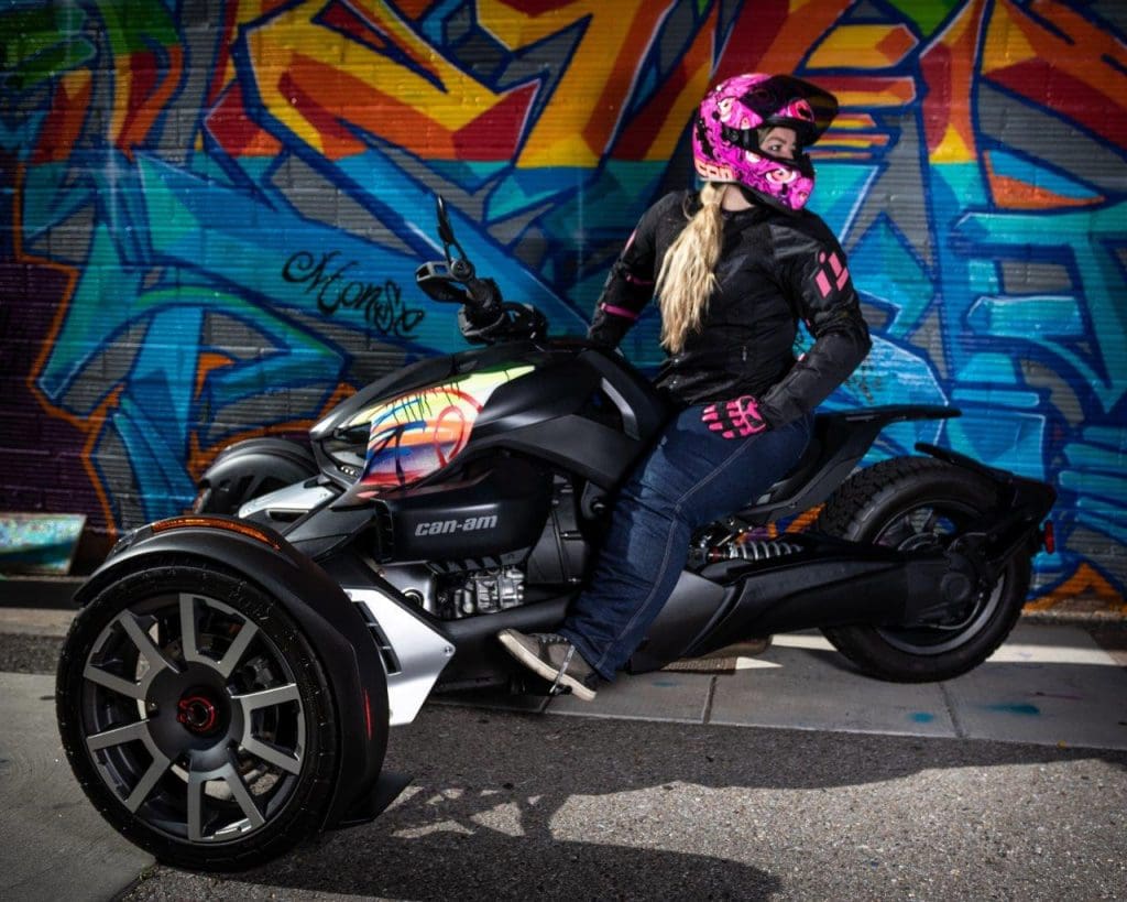 Rider posing with the Can-Am Ryker 900 Rally Edition