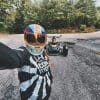 Brittany Morrow taking a selfie with the parked Can-Am Ryker 900 Rally Edition