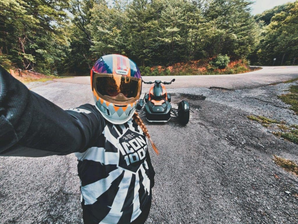 Brittany Morrow taking a selfie with the parked Can-Am Ryker 900 Rally Edition