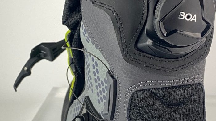 A Klim GTX Adventure boot with the BOA system tension released and the velcro flap opened. A Klim GTX Adventure boot with the BOA system tension released and the velcro flap opened.