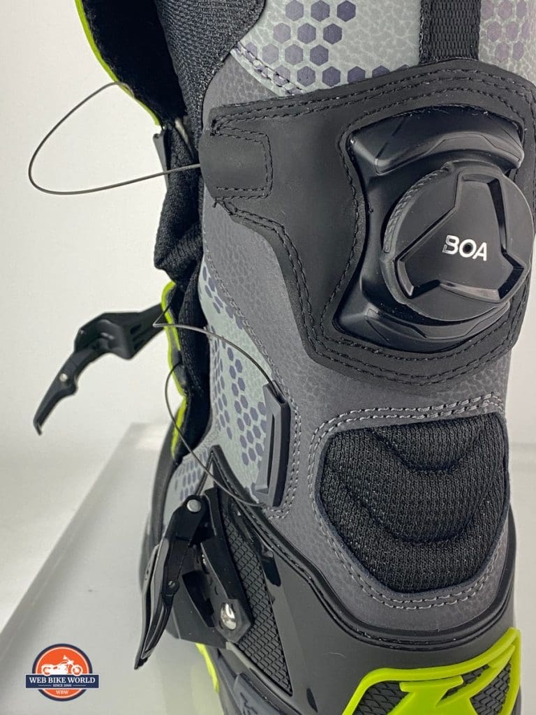 A Klim GTX Adventure boot with the BOA system tension released and the velcro flap opened.