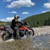 A KTM 790 adventure crossing a stream.