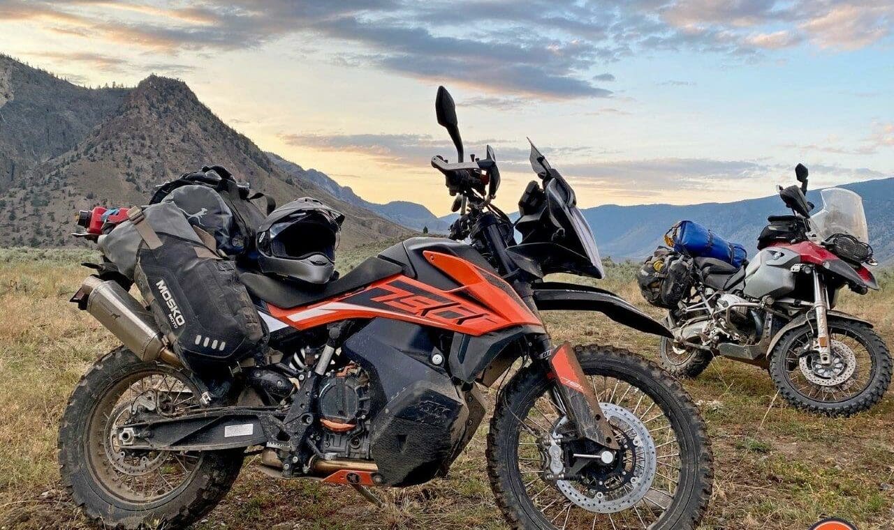 The Mosko Moto Reckless 80L V3.0 on a KTM 790 Adventure with a BMW R1200GS in the background.