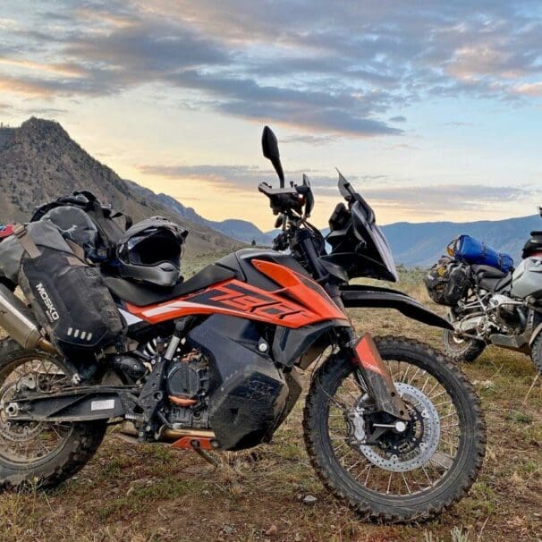 The Mosko Moto Reckless 80L V3.0 on a KTM 790 Adventure with a BMW R1200GS in the background.