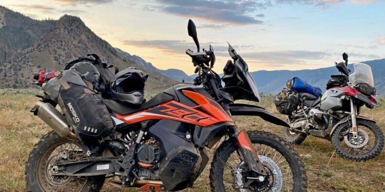 The Mosko Moto Reckless 80L V3.0 on a KTM 790 Adventure with a BMW R1200GS in the background.