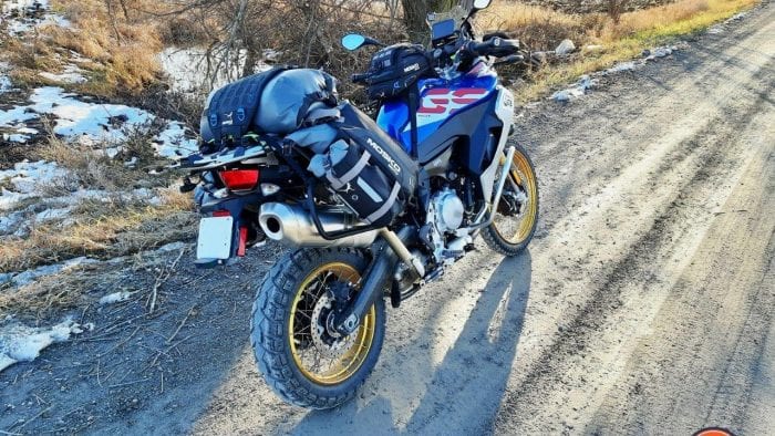A 2020 BMW F850GS Adventure parked on a country road with the Mosko Moto Reckless 80L v3.0 Revolver luggage installed. A 2020 BMW F850GS Adventure parked on a country road with the Mosko Moto Reckless 80L v3.0 Revolver luggage installed.
