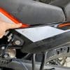 A rubbed through seat cover on my KTM 790 Adventure due to a poorly routed strap from the Mosko Moto Reckless 80L V3.0 Revolver.