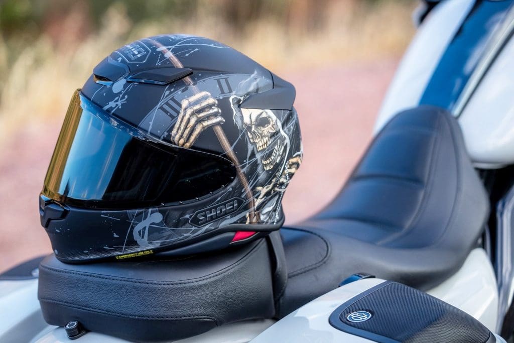 The new Shoei RF-1400 helmet sitting on a Harley Davidson seat.