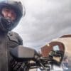 Rider testing out the waterproofing features of the Transit 3.0 suit