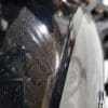 A closeup of the tank cover on the Indian FTR 1200 S in Titanium Metallic over Thunder Black Pearl paint