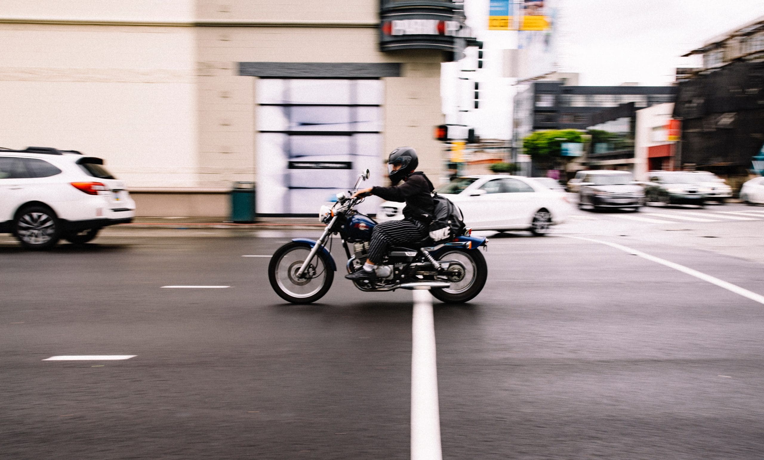 man riding motorcycle on city roads