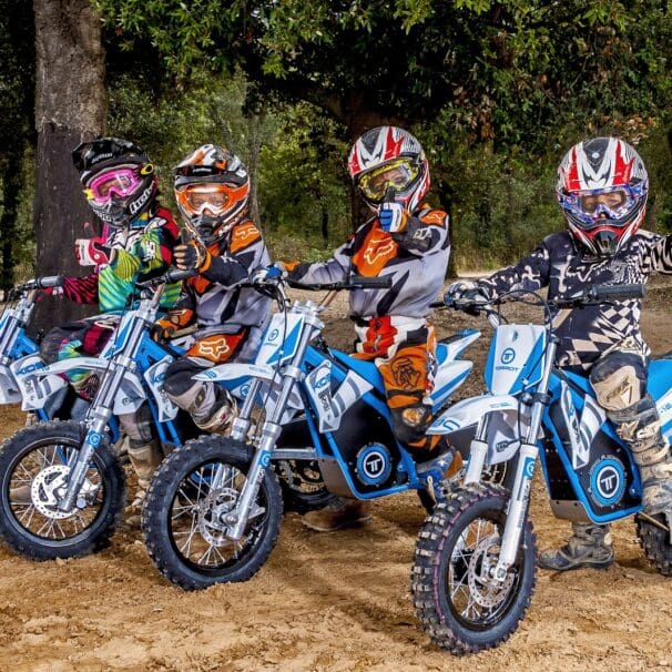 A line of kids trying out the Torrot electric dirt bikes