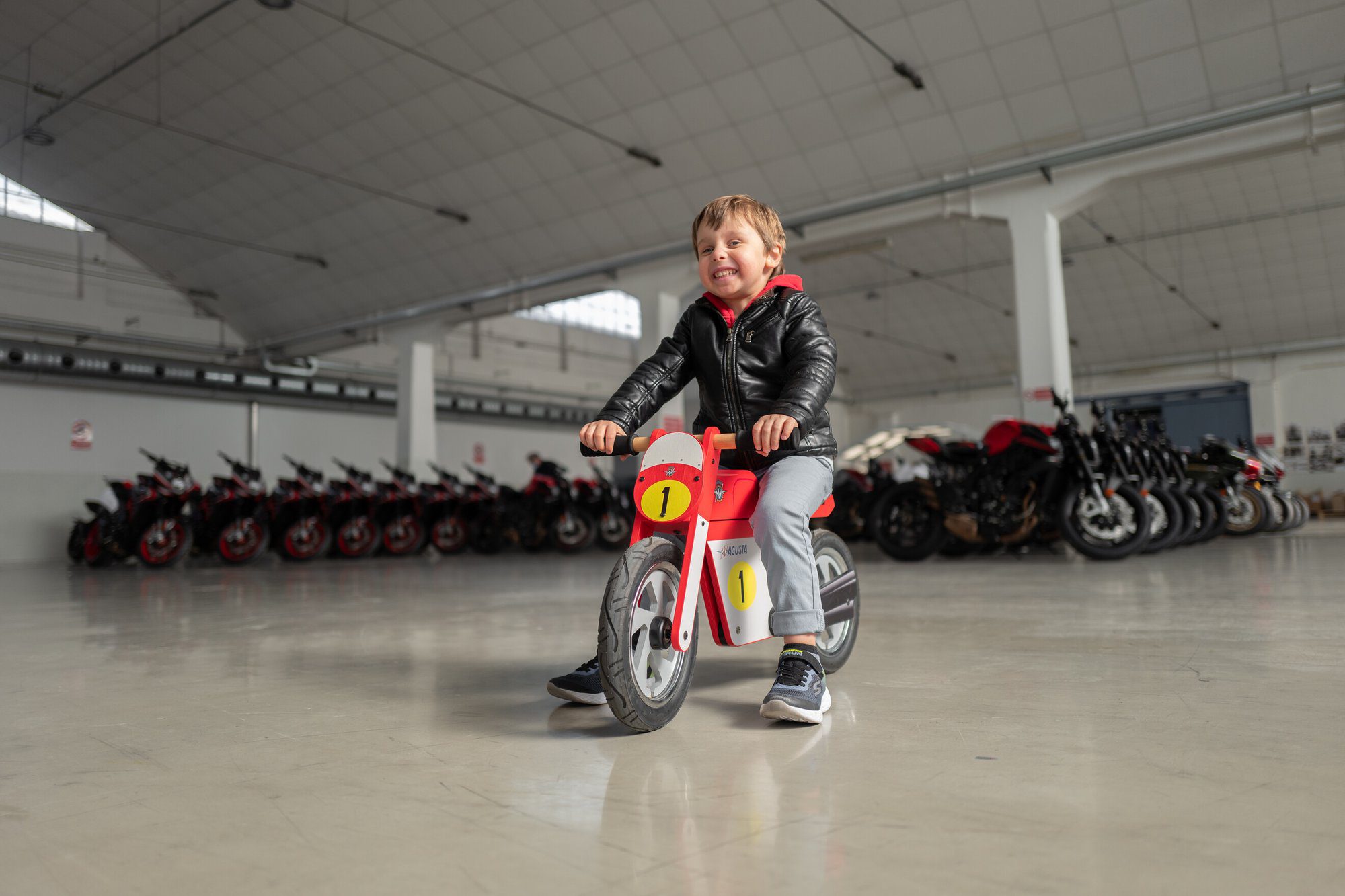 kid having fun with MV Agusta's new Vintage Wooden Balance Bike