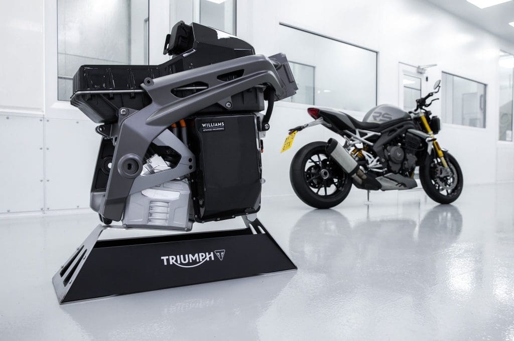 Triumph's TE-1 Electric Superbike Engine with a current petrol-engined Triumph bike in the background