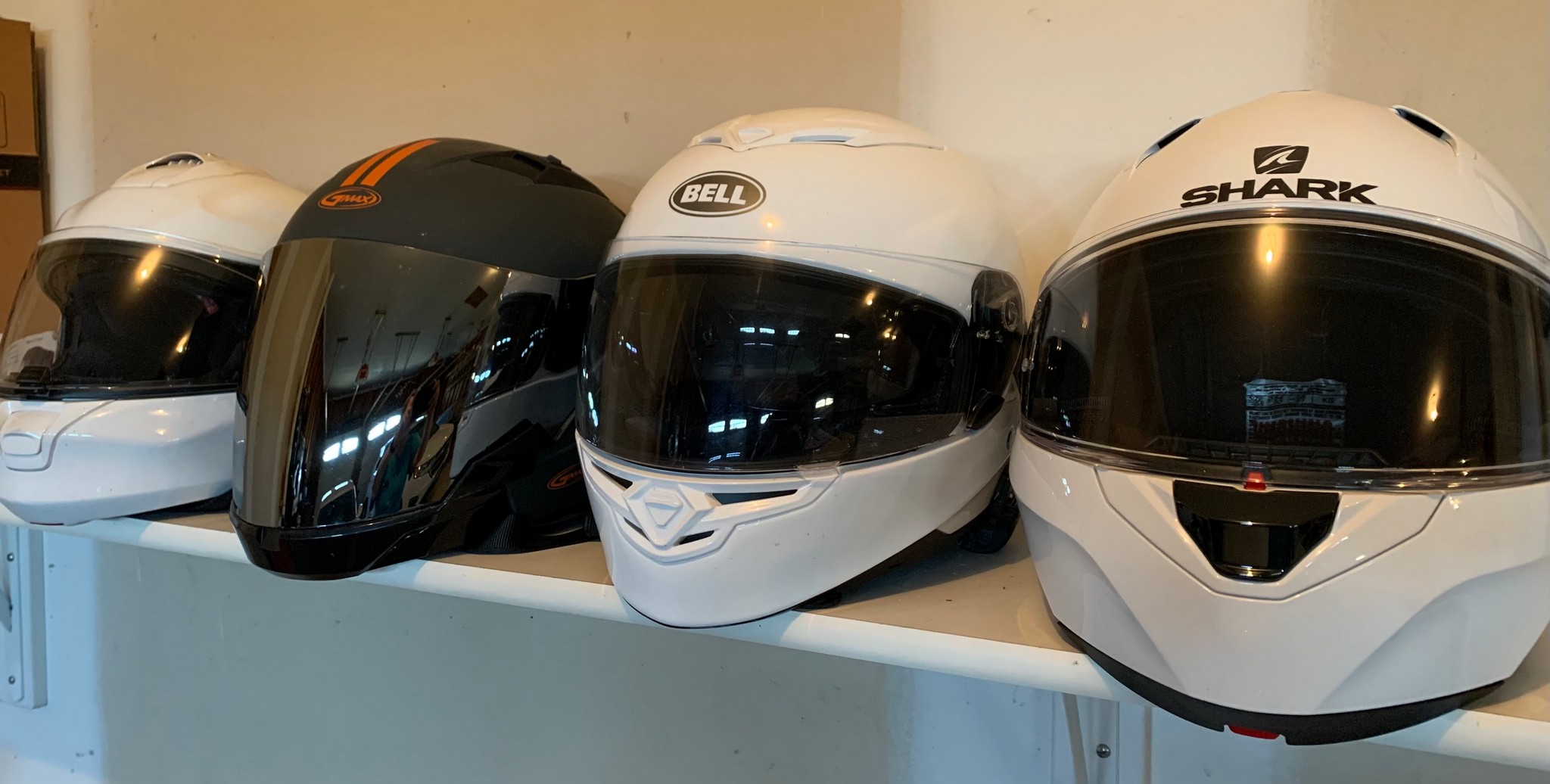 Motorcycle helmets on a shelf